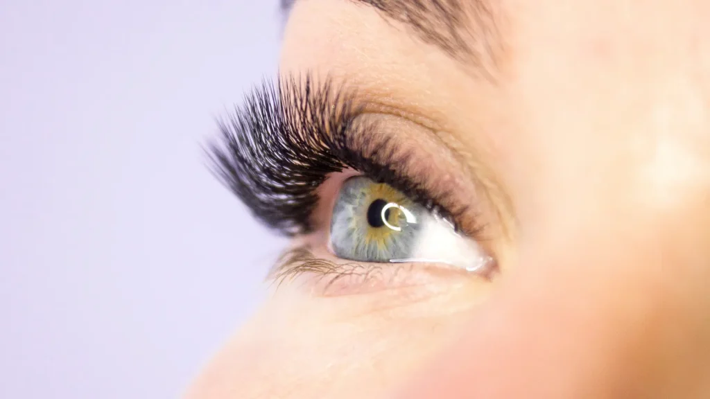 An individual with longer and thicker eyelashes.