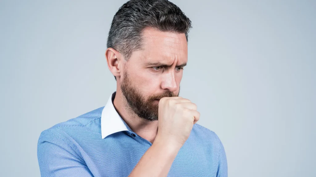 An individual dealing with respiratory issues like coughing.