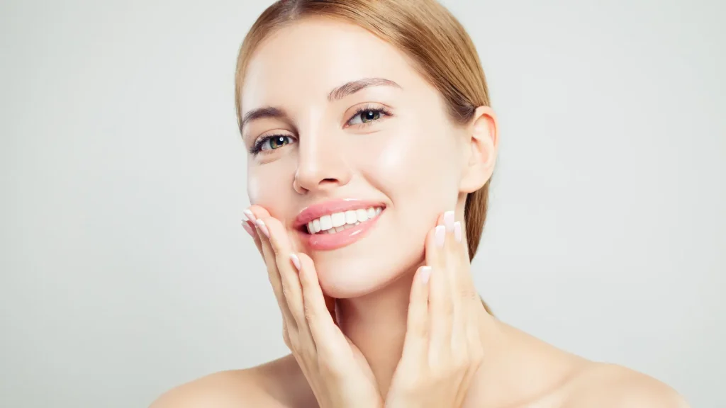 A woman flexing their smooth and clear facial skin.