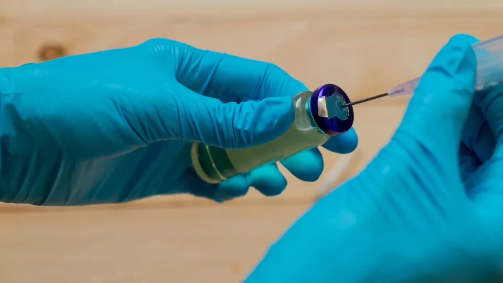 A medical professional preparing the injection.