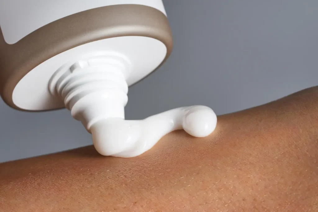 A close-up shot of a cream application on skin.