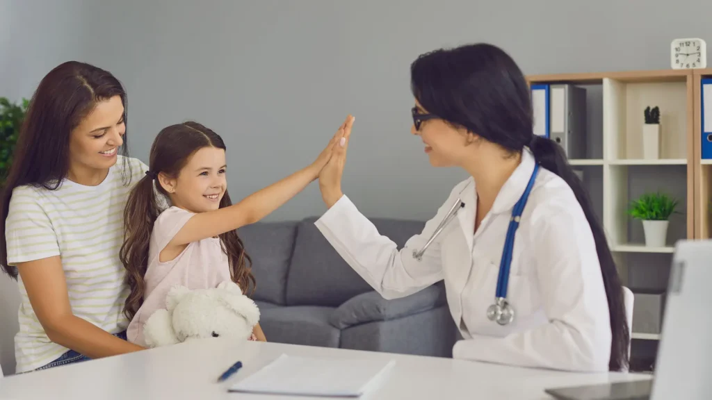 A doctor during a consultation with a parent and child.