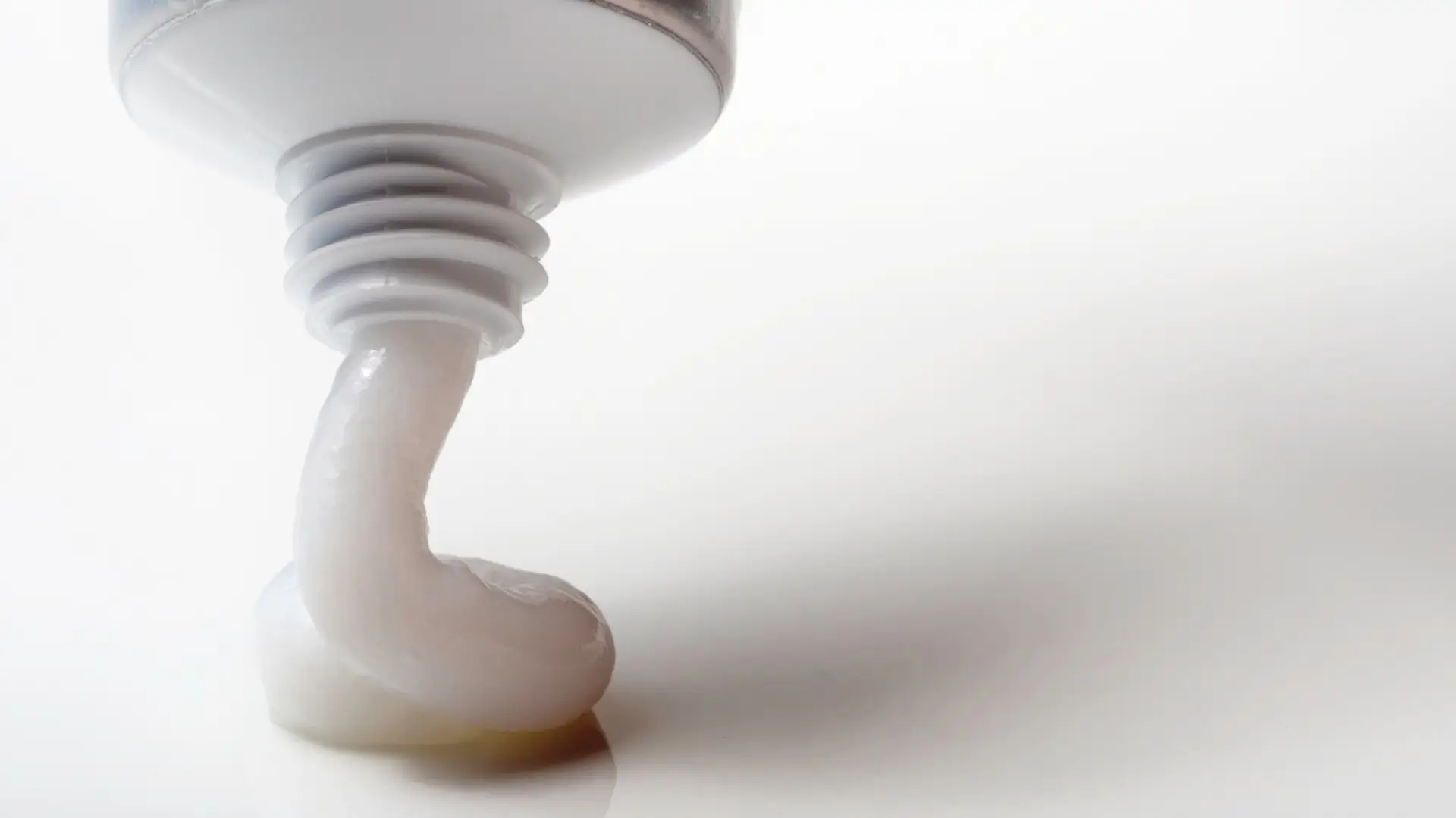 A close-up shot of a medicine cream from a tube.