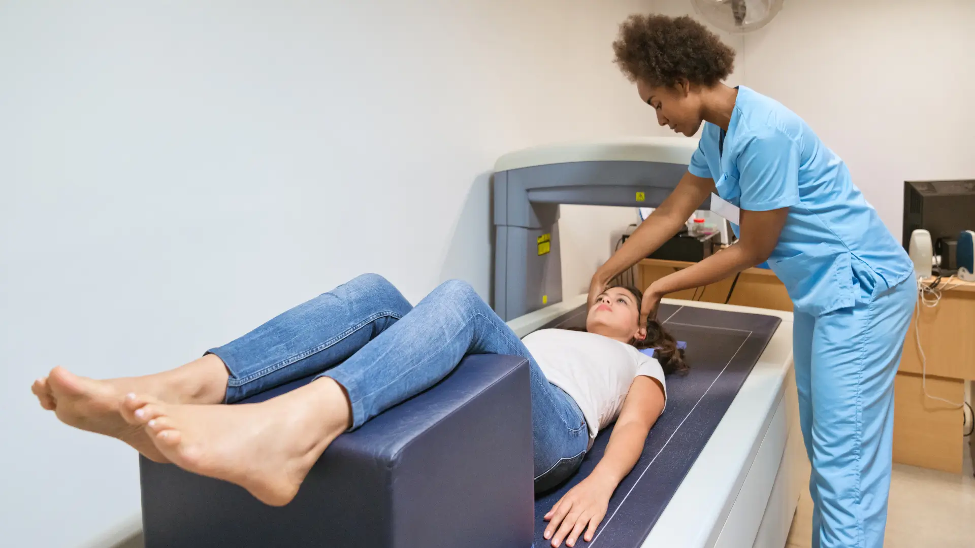 A woman preparing to undergo a bone density scan.