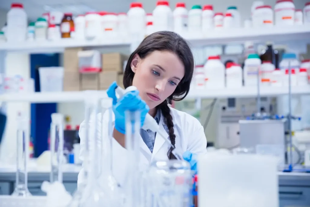 A scientist working with formulations in a medical laboratory.