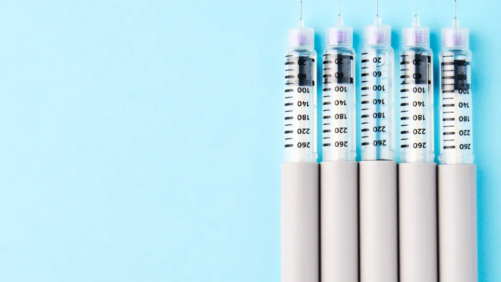 Multiple injection pens on a surface.