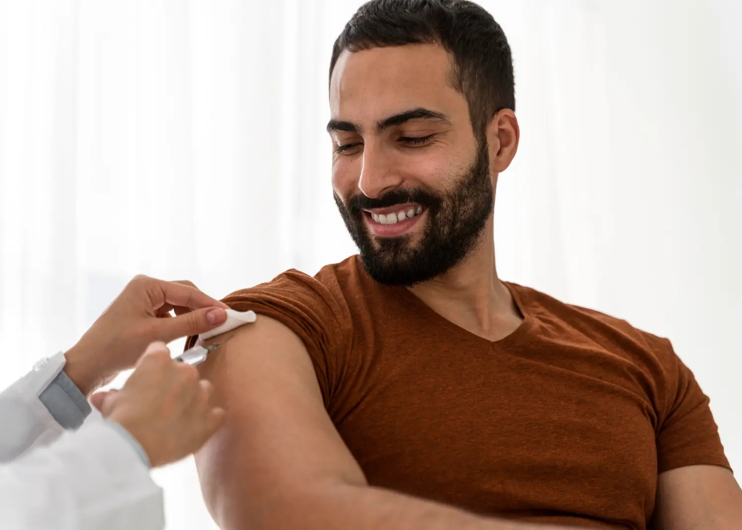 A male individual receiving an arm injection.