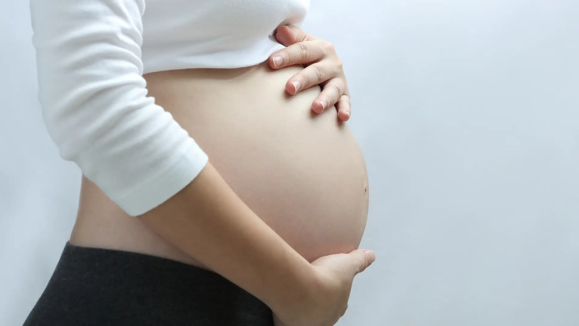 A close-up shot of a pregnant woman's belly.
