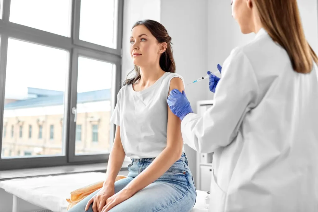 An individual receiving an injection from a medical professional.
