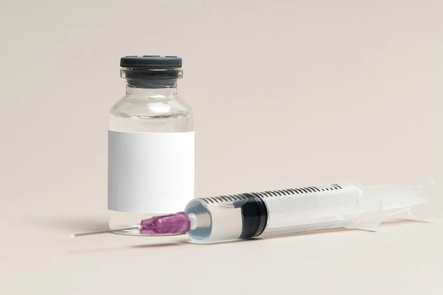 A medical vial and syringe.