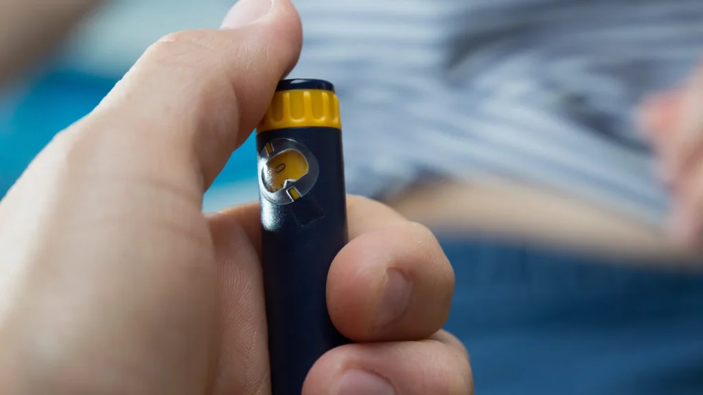 An individual preparing the injection pen.