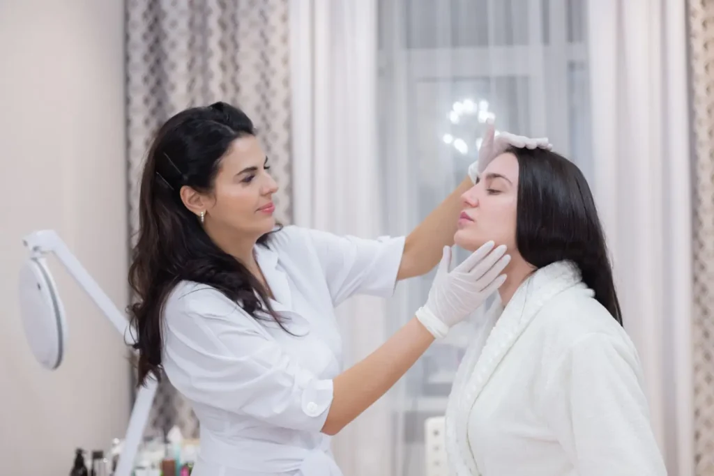 A doctor and patient consultation for the patient's facial treatment.