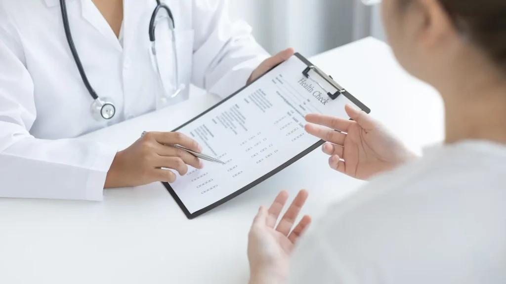 An individual undergoing an assessment with their medical provider.