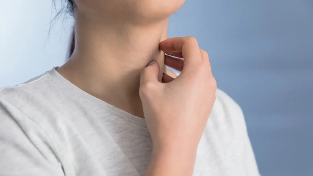 An individual with allergy, scratching their itchy neck.