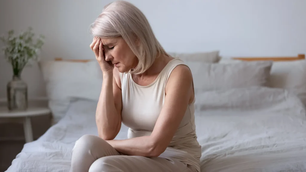 An older individual suffering from headache.