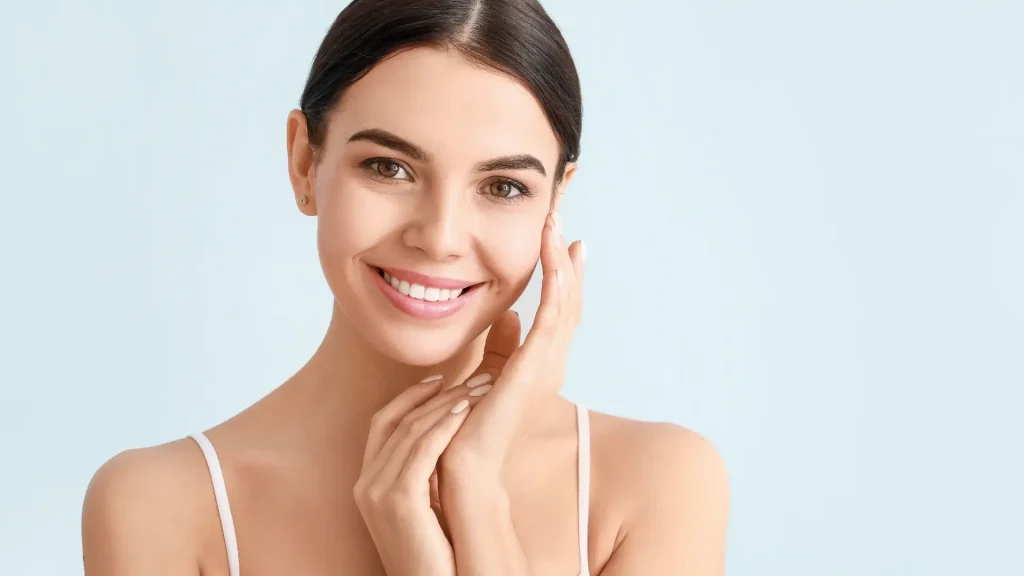 A woman showing off her smooth, clear facial skin.