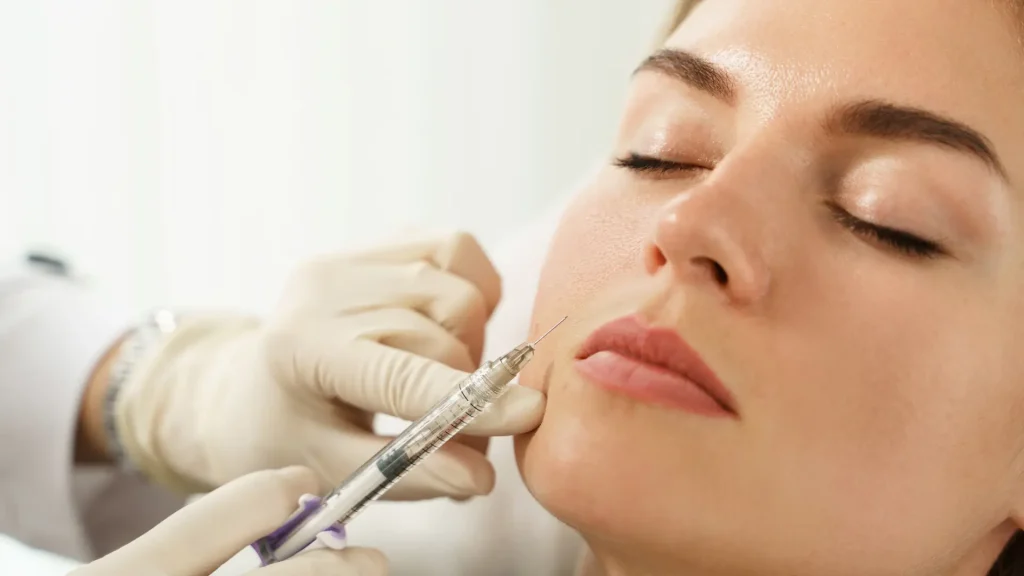 A female individual receiving an injection for their lower face wrinkles.