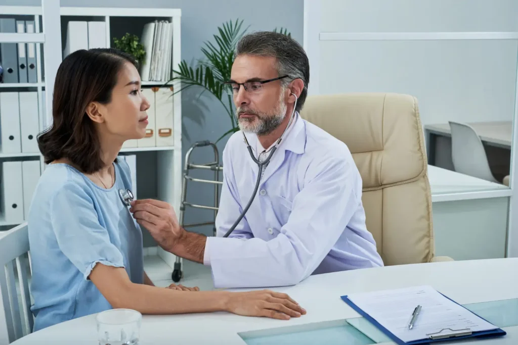 A doctor examining the patient during a consultation.
