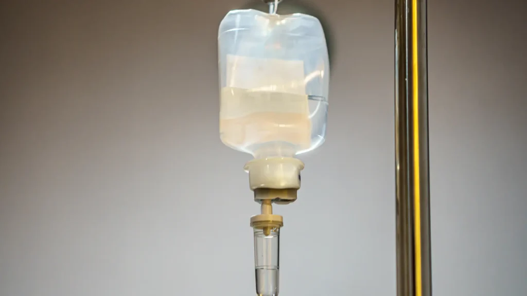 A close-up shot of a medical IV infusion bottle.
