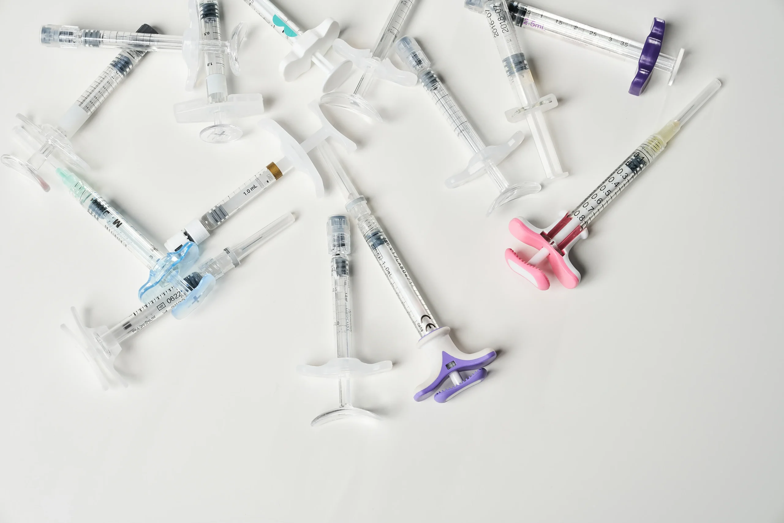 A top view of various aesthetic injections on a surface.
