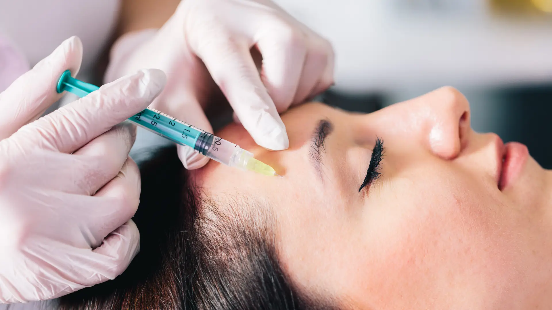 An individual receiving an injection for their facial region.