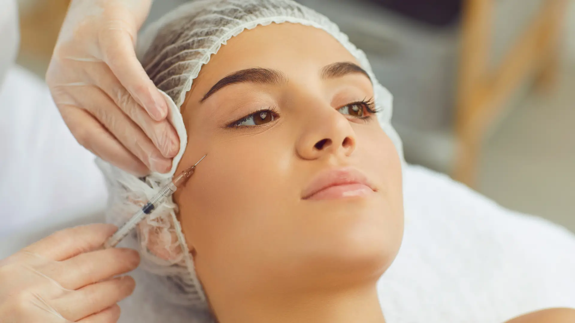 An individual receiving an injection for their facial skin concerns.