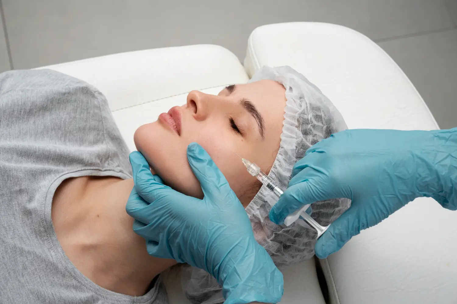 An individual receiving an aesthetic injection for their facial concerns.