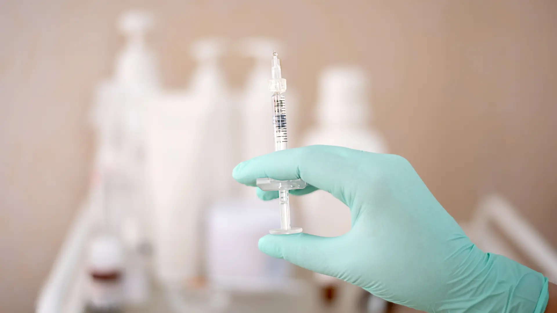 A medical professional holding an aesthetic injection.