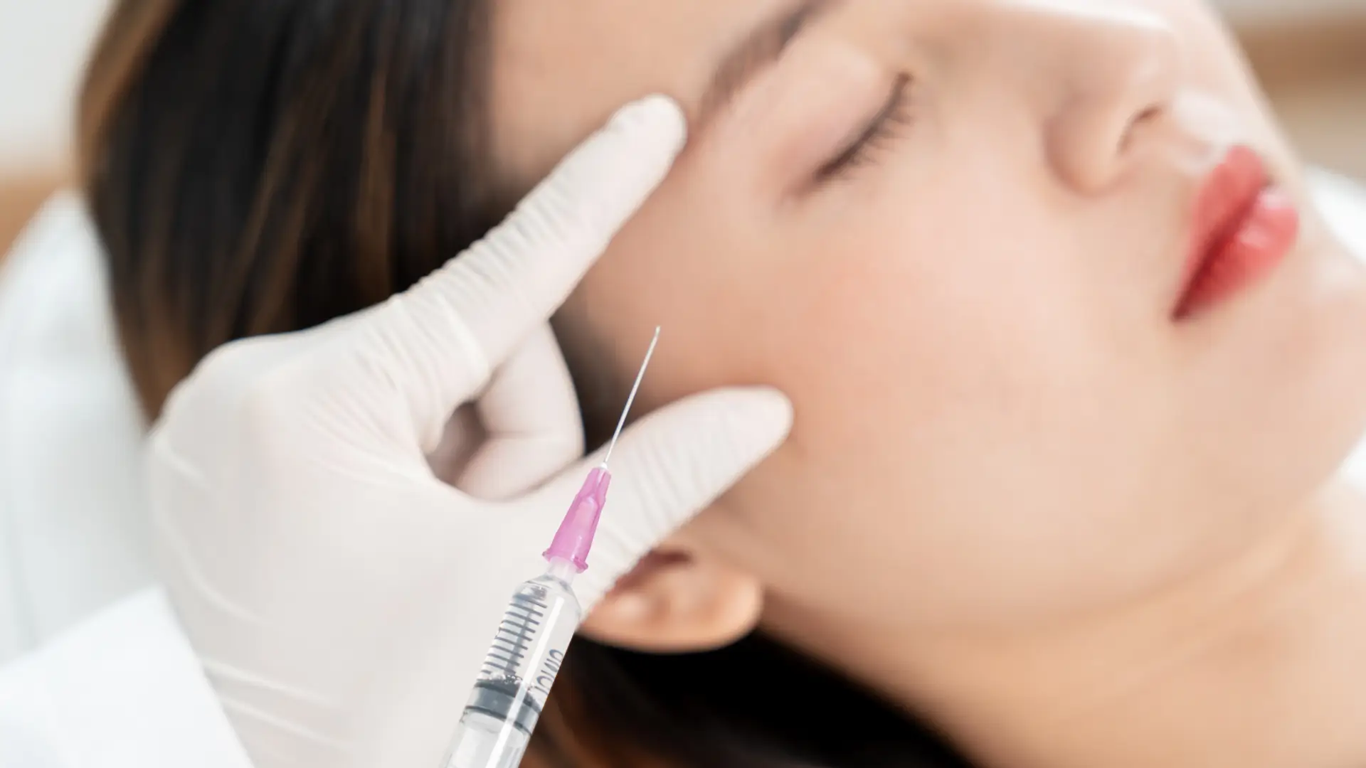 A patient receiving an anti-aging injection from a medical professional.
