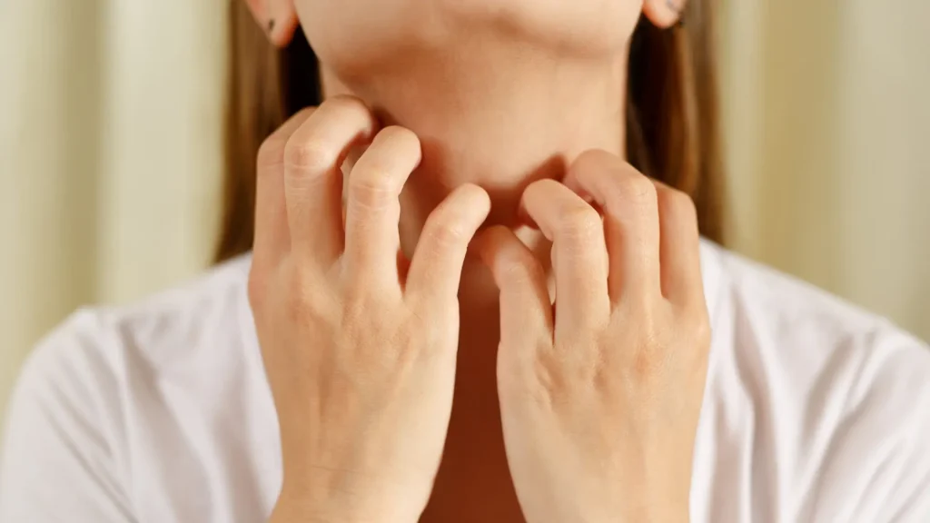 An individual experiencing severe itching on their throat.