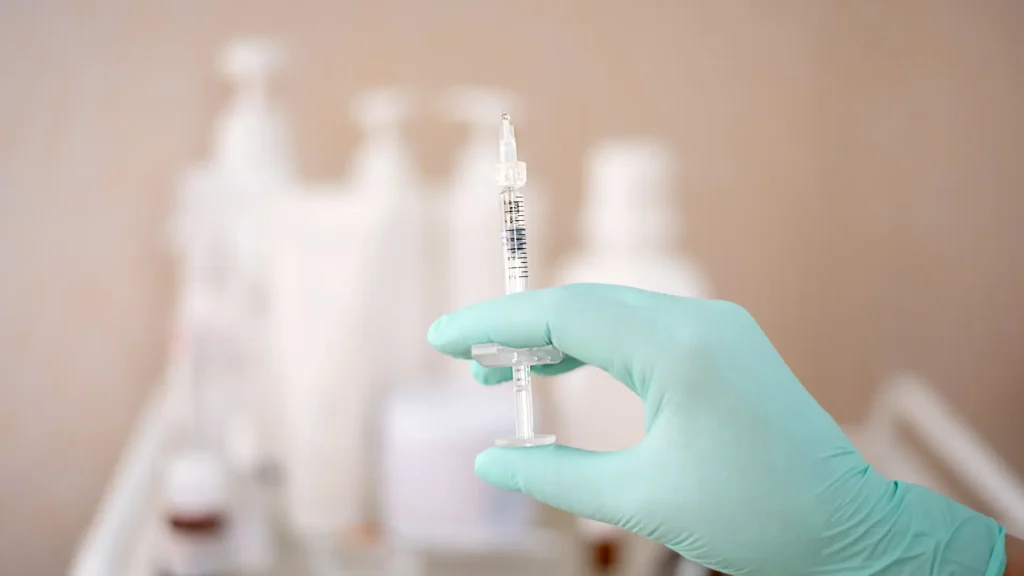 A medical professional holding an aesthetic injection.