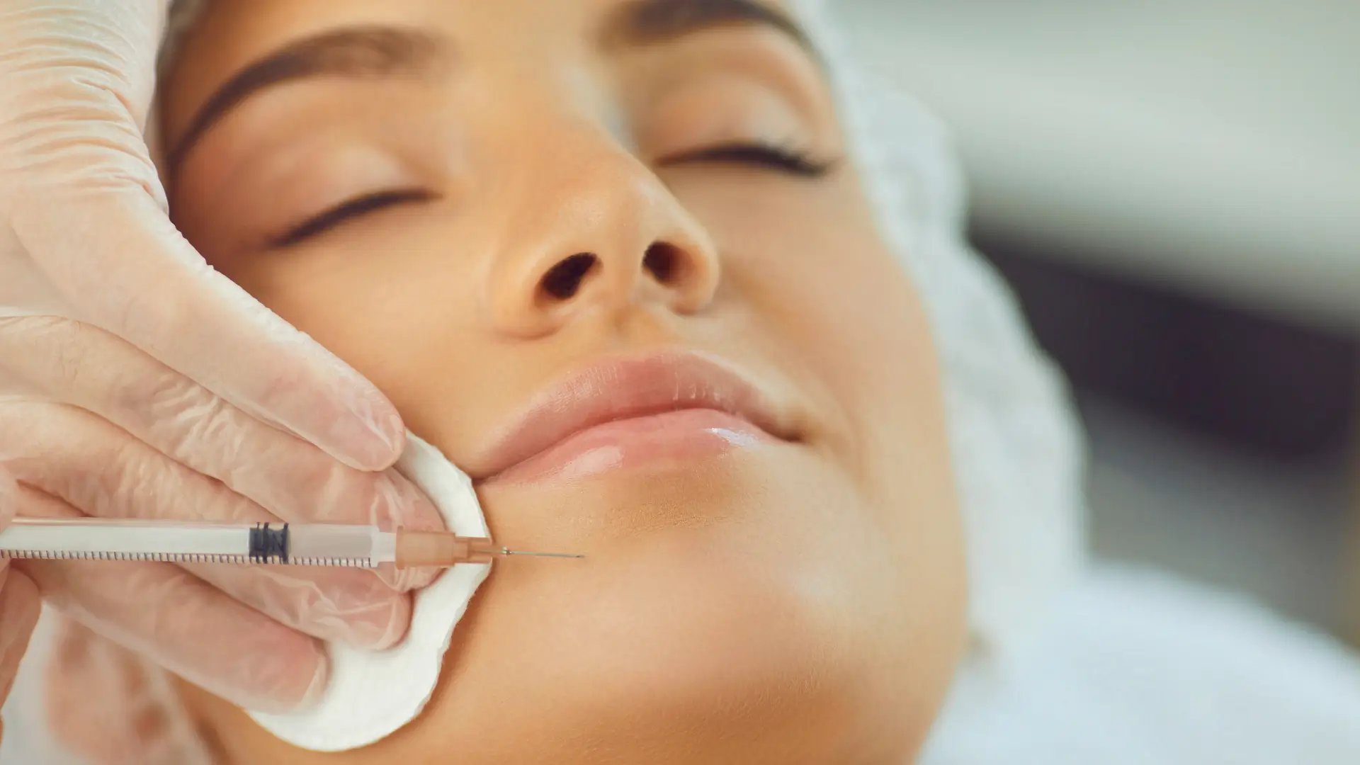 A medical professional administering an aesthetic injection.