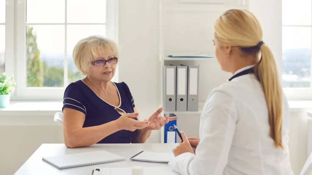 An older patient undergoing a consultation with a medical professional.