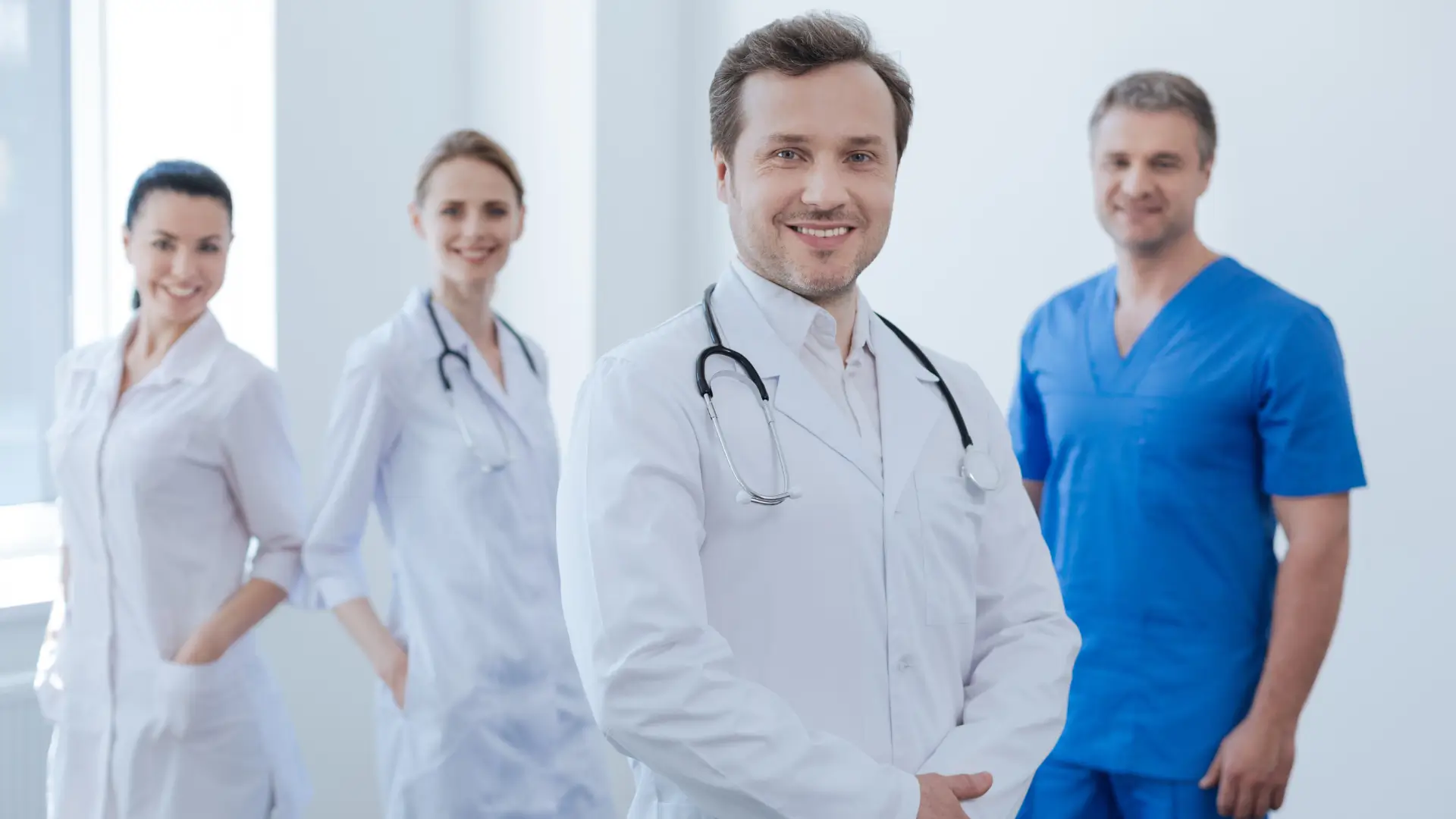 Four medical practitioners pose for a photo.