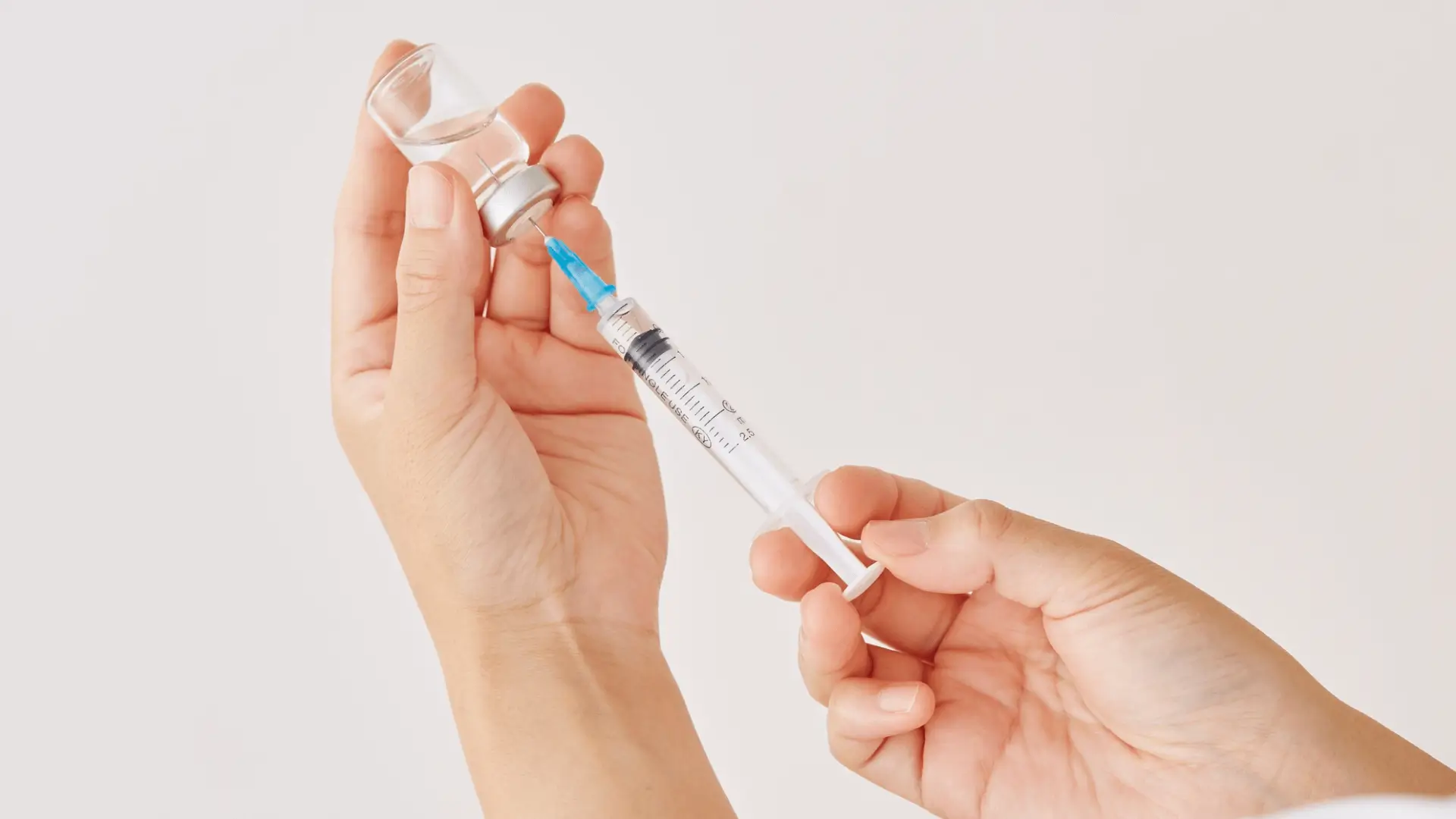 A medical provider preparing the injection for treatment.