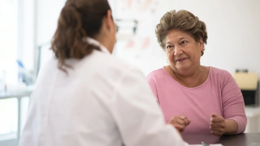 A doctor and older woman during a counseling session.