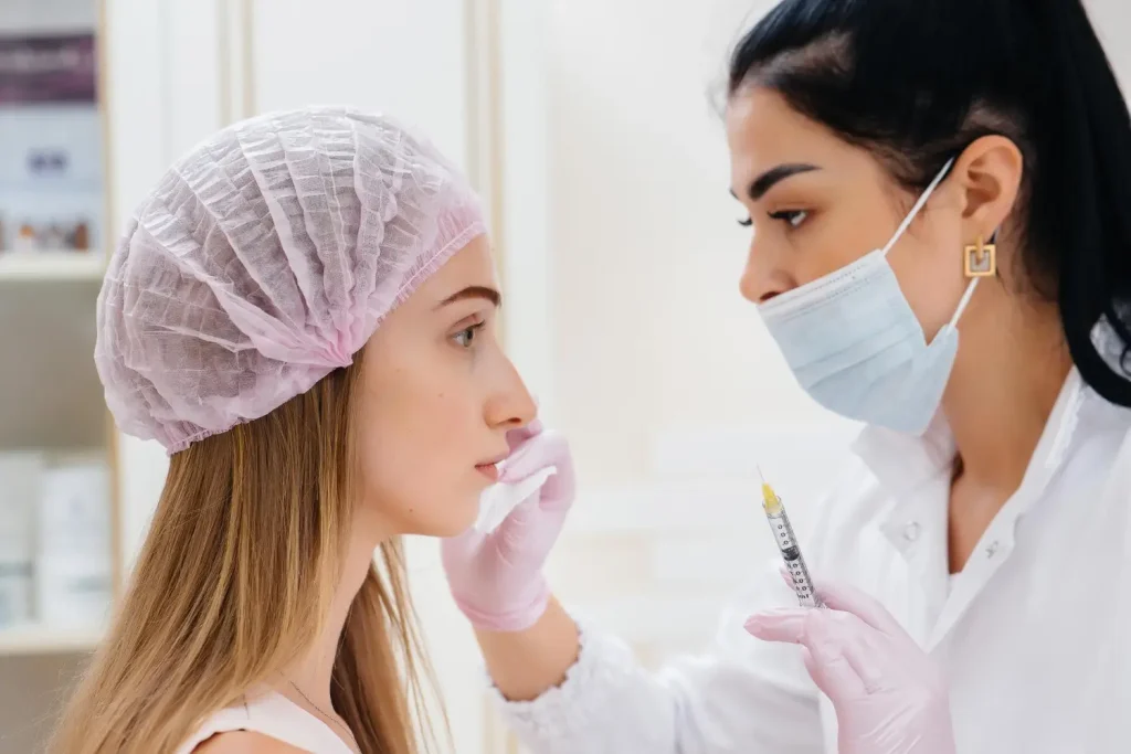 An aesthetic provider preparing patient for a facial injection.
