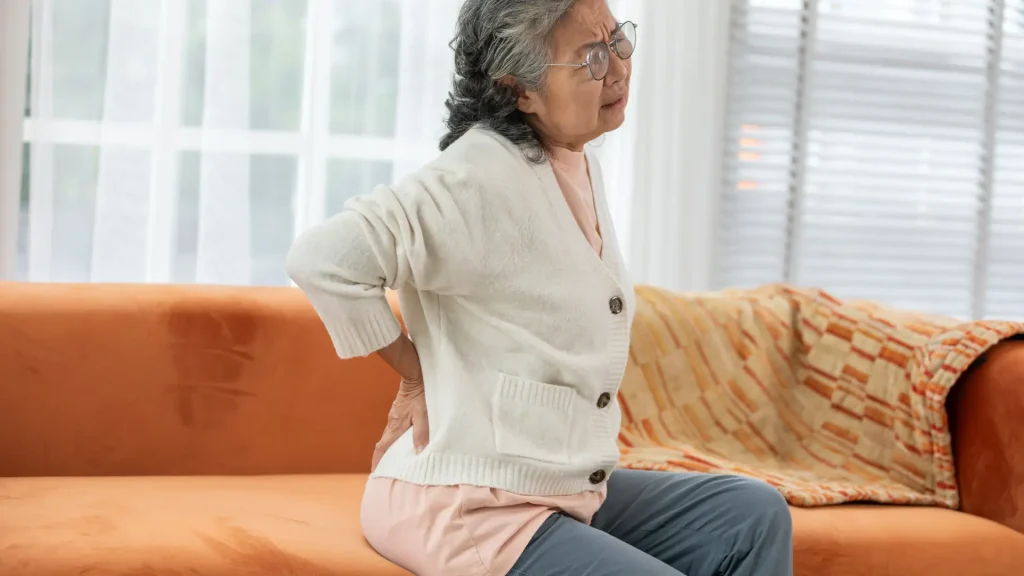 An older individual dealing with severe back pain.