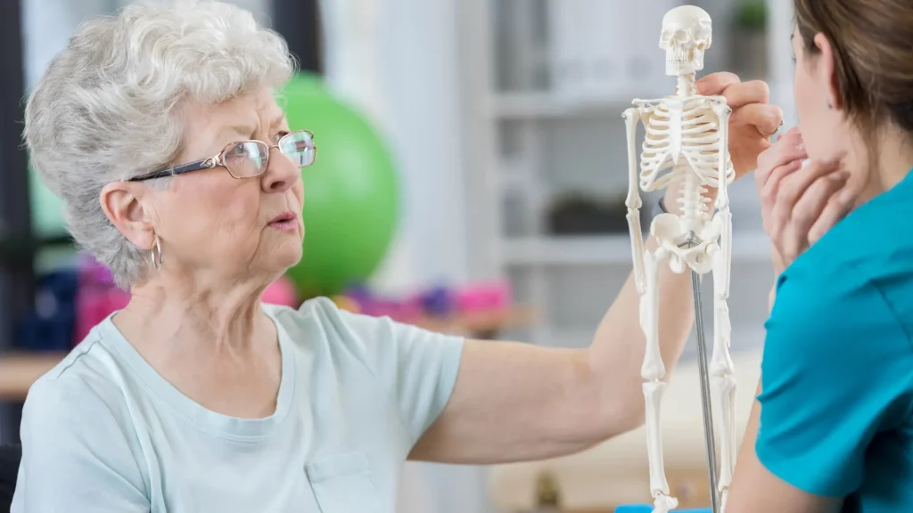 A doctor and older patient consultation on their osteoporosis.