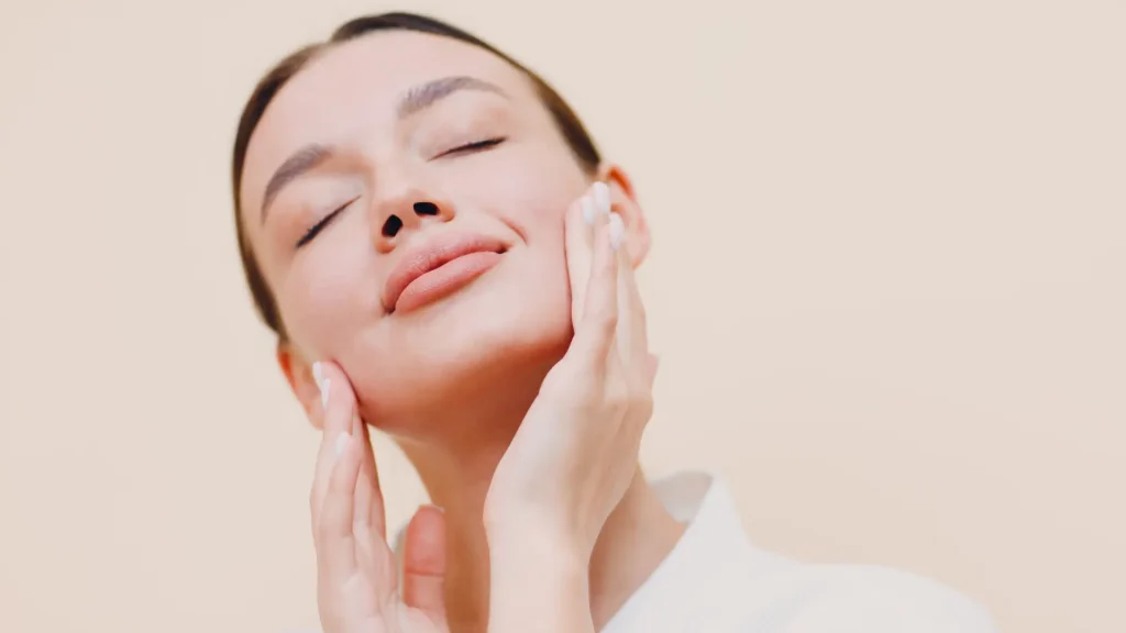 A woman showing off their clear, smooth skin.