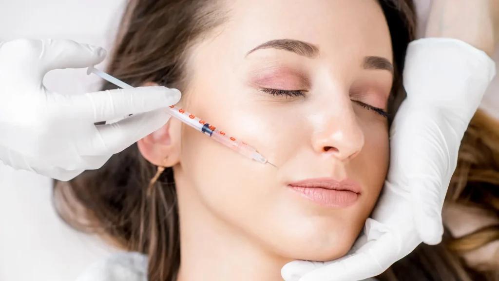 An individual receiving a cosmetic botox injection for their smile lines.
