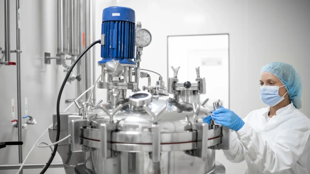 A medical scientist in a pharmaceutical manufacturing setting.