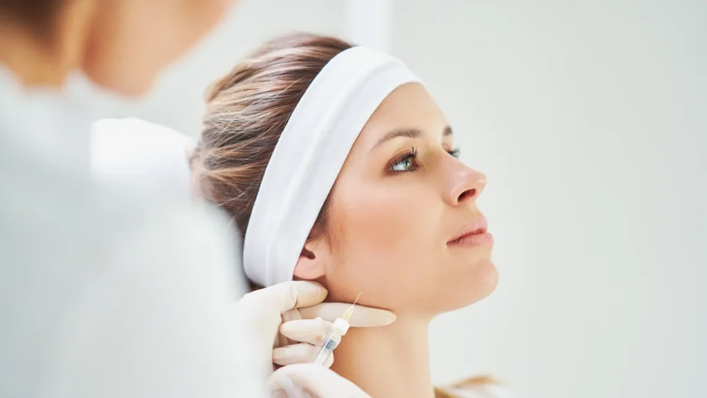 A patient receiving an injection for their masseter region.