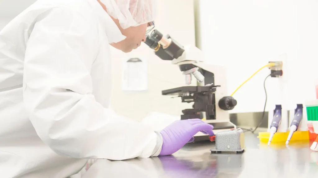 A medical scientist working on a formulation in a laboratory.