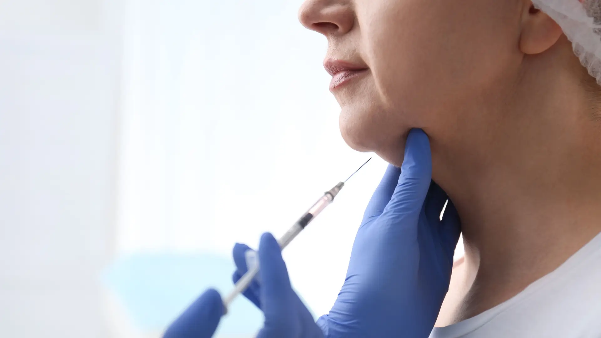 An individual receiving an injection for their double chin fat.