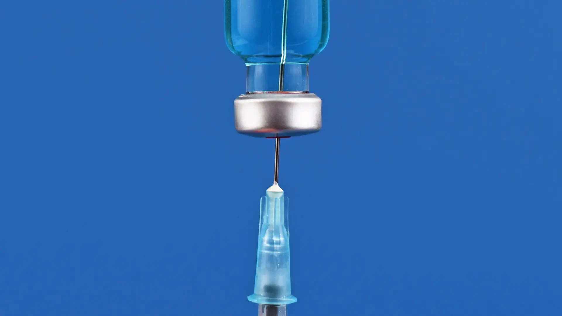 A close-up shot of a syringe and medication vial.