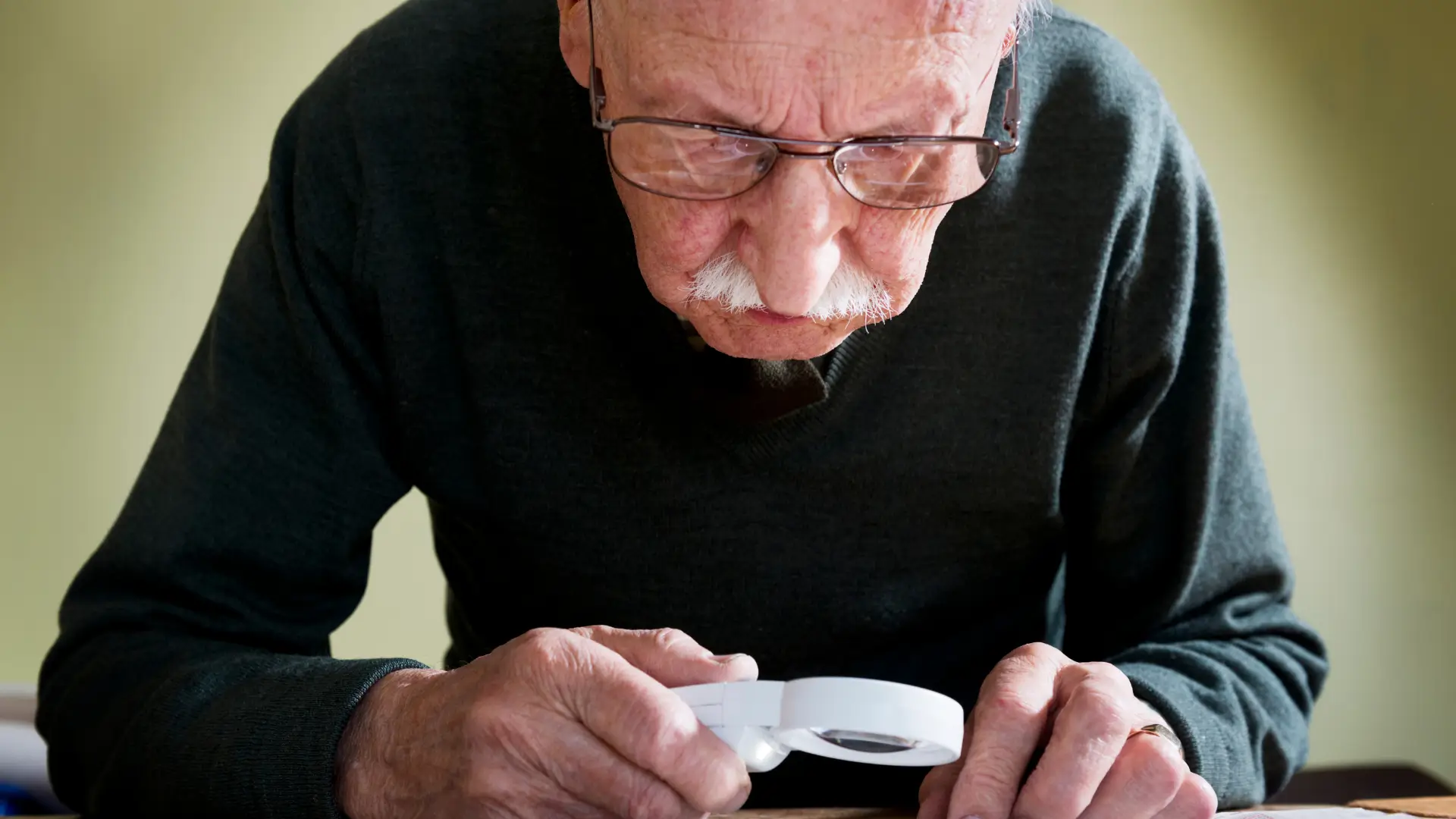 An older individual suffering from macular degeneration.