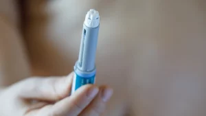 An individual holding an injection for diabetes.