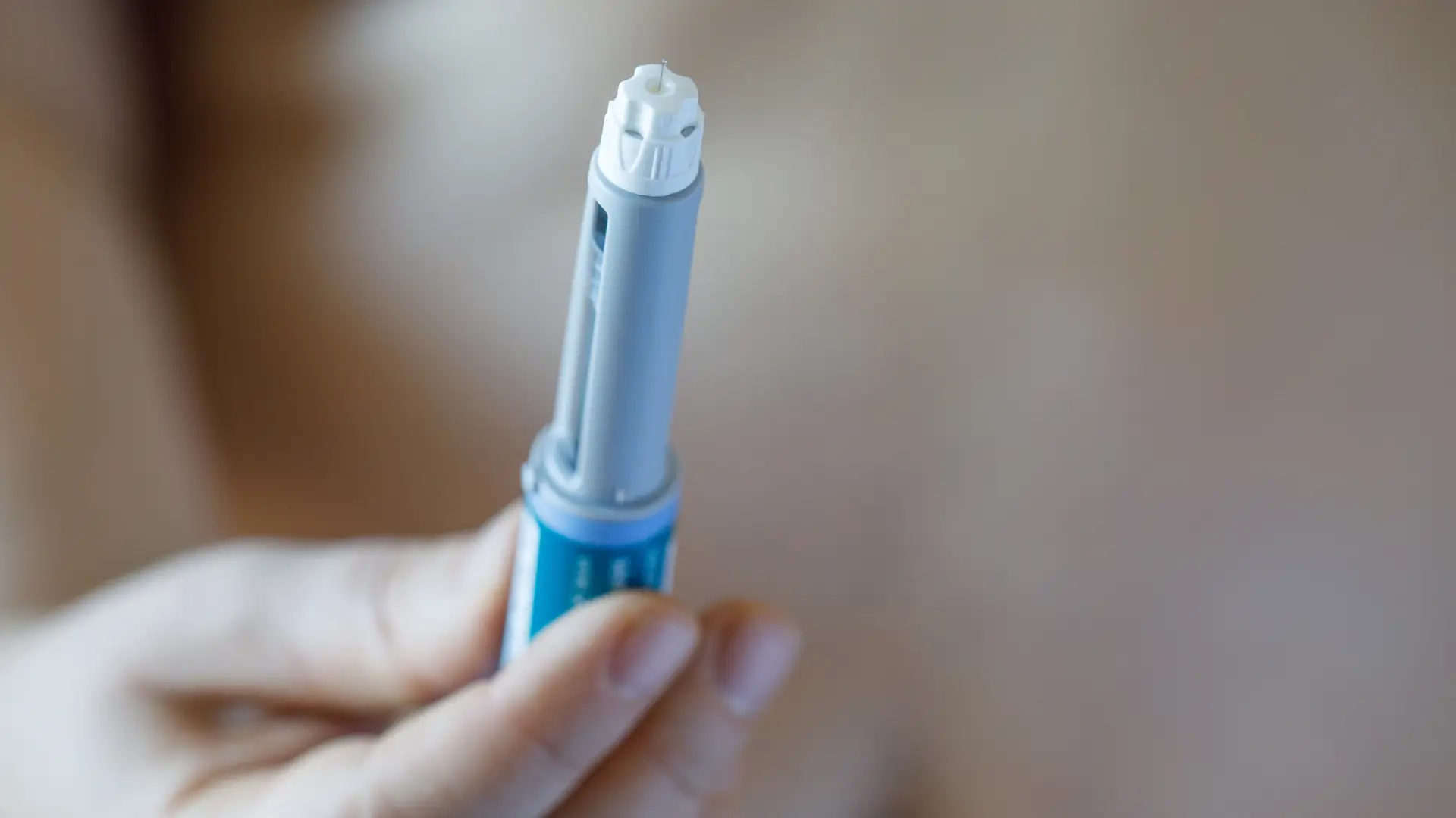 An individual holding an injection for diabetes.