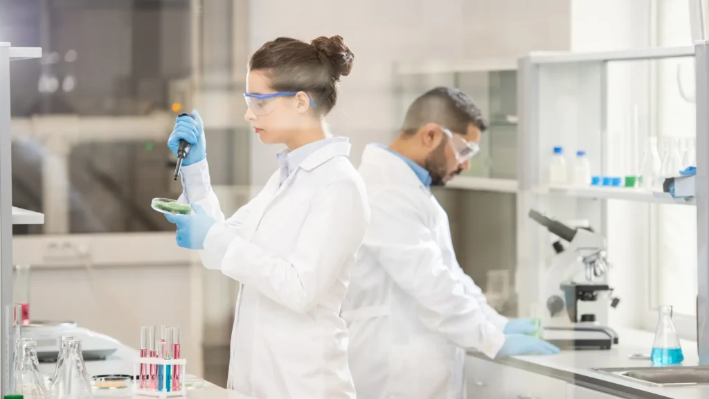 Scientists compounding solutions.